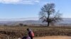 A boy pushes a suitcase as he walks with other migrants and refugees after crossing the Macedonian border into Serbia near the village of Miratovac. (AFP/Armend Nimani)