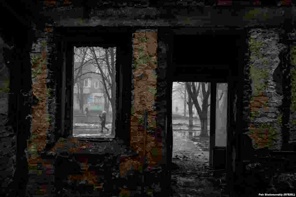 A view of the street through a blown-out window and door