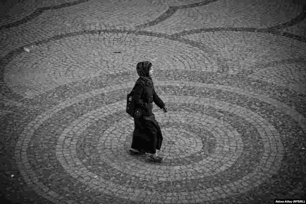 A woman walks through a city square in Irbil. Atilay notes that women in the Kurdish region seem to enjoy greater freedom of movement and dress than in many parts of Iraq.