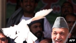 Afghan President Hamid Karzai releases a dove while campaigning in Herat in August