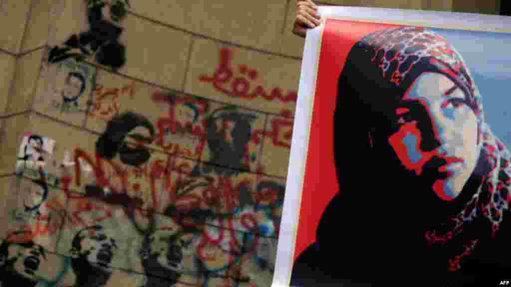 An Egyptian protester holds a picture of Samira Ibrahim, who accused an army doctor of conducting forced "virginity tests" on female protesters, during a demonstration in solidarity with Ibrahim in Cairo. (AFP/Mohammed Hossam)