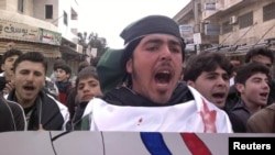 Demonstrators shout during a protest against Syria's President Bashar Assad, in Kafranbel near Idlib, on February 19.