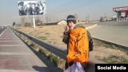 IRAN -- Dissident Mohammad Maleki engaging in a protest action by picking up trash.