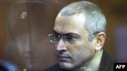 Former Yukos oil company chief executive officer Mikhail Khodorkovsky stands behind a glass wall at a courtroom in Moscow, 29Dec2010