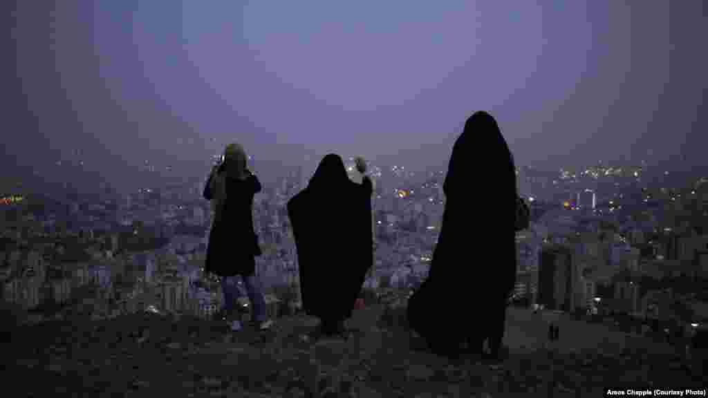 Women in the hills above Tehran at dusk