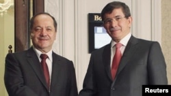 Turkish Foreign Minister Ahmet Davutoglu (right) with Iraqi Kurdish Regional President Massoud Barzani before their meeting in Istanbul.