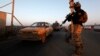 An Iraqi soldier stands guard at a check point in west Baghdad. (file photo)