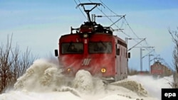 A snowplow train clears tracks after heavy snowfalls in Serbia in February.