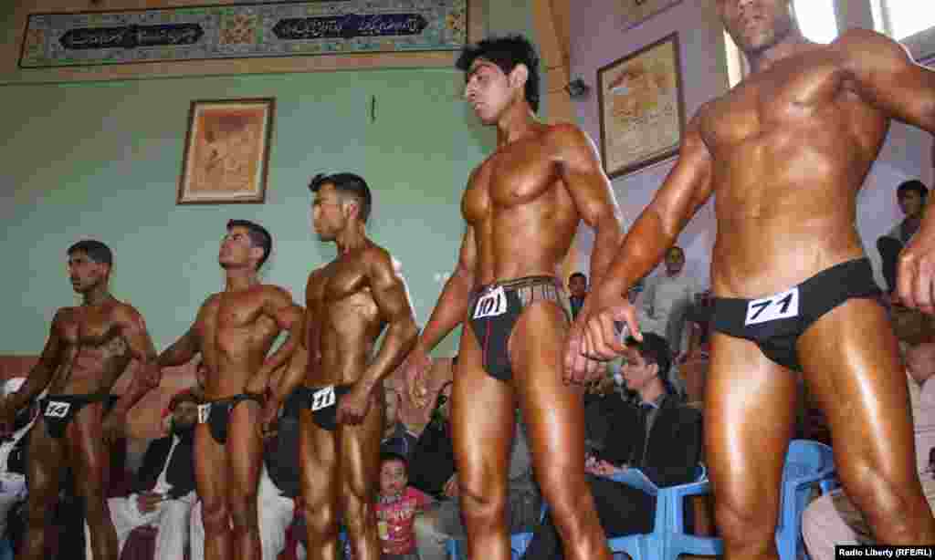 Afghanistan -- Men strike a pose during a National bodybuilding competition in Kabul on 15march 2013