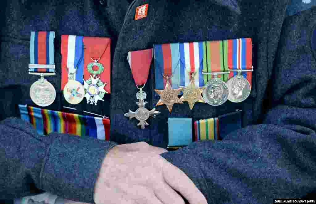 FRANCE -- Medals are pinned on the jacket of Canadian veteran Leon Teacher, 96, prior the international ceremony on Juno Beach in Courseulles-sur-Mer, Normandy, northwestern France, on June 6, 2019