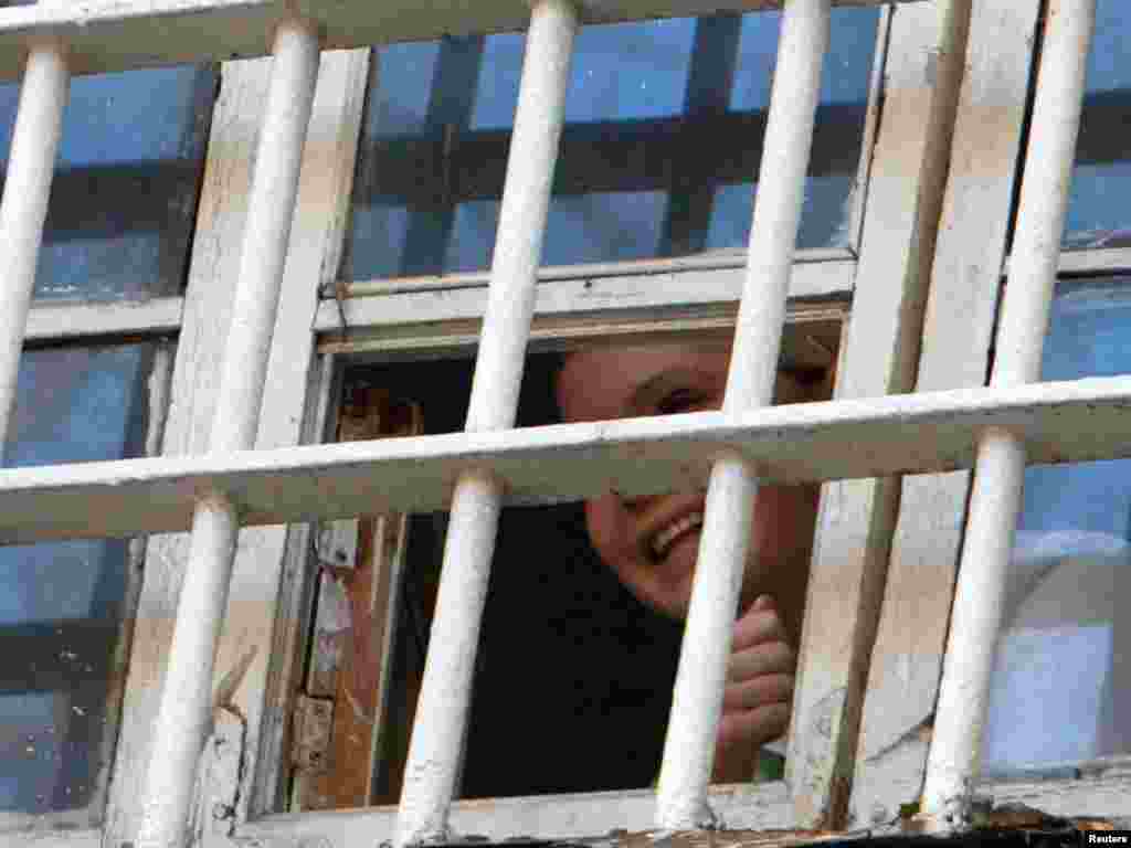 Tymoshenko peeks through a prison window in Kyiv on November 4, 2011.