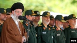 Iran's Supreme Leader Ayatollah Ali Khamenei (left) speaks during a visit to the Imam Hussein Military College in Tehran on May 20.