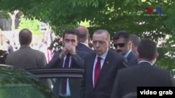 Turkish President Recep Tayyip Erdogan (c) watching the brawl in Washington