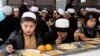 FILE: Afghan orphans, who lost their parents in conflicts, eat a meal at Sheikh Mohammed Bin Rashid al-Maktoum orphanage house, in the southern Afghan city of Kandahar.