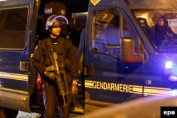 French police react after a shooting in which a police officer was killed.