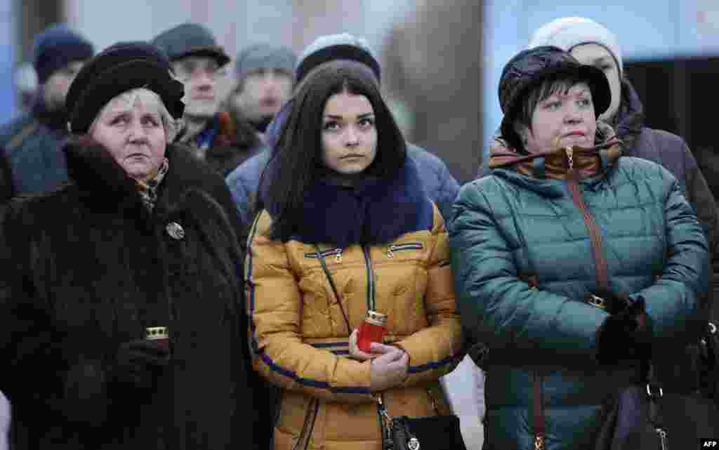 Residents of the self-proclaimed Donetsk People's Republic take part in a vigil for children killed in the conflict in Donetsk. The vigil took place after a young girl was accidentally killed by a Ukrainian armored vehicle in the Ukrainian-held town of Konstantinovka, sparking riots there. (AFP/Aleksandr Gayuk)