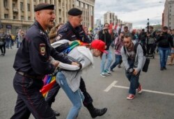 Russian police detain an LGBT activist during a protest in Moscow in August 2017.