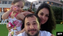 Roman Seleznyov (center), the son of a Russian lawmaker from the Liberal Democratic Party, poses with his partner Anna Otisko (right) and their daughter.