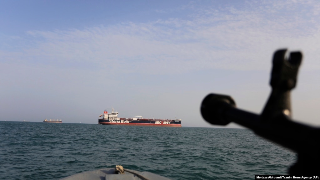A speedboat of Iran's Revolutionary Guard trains a weapon toward the British-flagged oil tanker Stena Impero, which was seized in the Strait of Hormuz on Friday by the Guard, in the Iranian port of Bandar Abbas, July 21, 2019