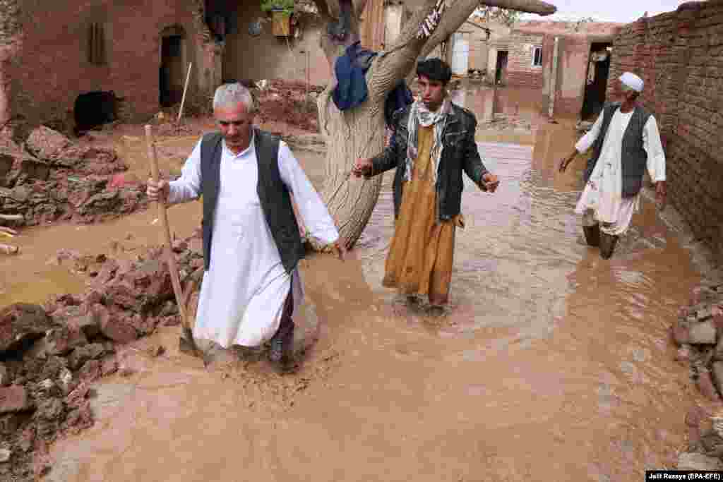 Afghan people affected by seasonal floods salvage their belongings from damaged houses in Herat on March 29. (epa-EFE/Jalil Rezayee)