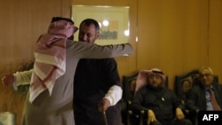 A former Yemeni inmate, released from the U.S. military prison in Guantanamo Bay, is welcomed by his family upon his arrival in Riyadh on January 5.