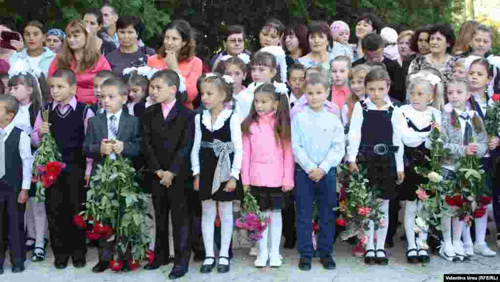 Children carry roses in Balanesti, Moldova.