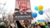 A demonstrator holds a placard at a protest against Russia's war on Ukraine in Almaty, Kazakhstan.