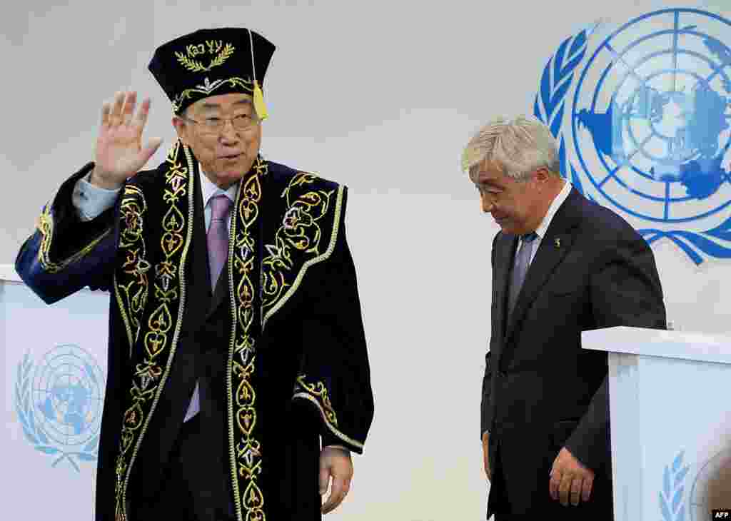 UN Secretary-General Ban Ki-moon (left) wears a traditional Kazakh outfit after he officially opened the organization's new office building in Astana. (AFP/Ilyas Omarov)