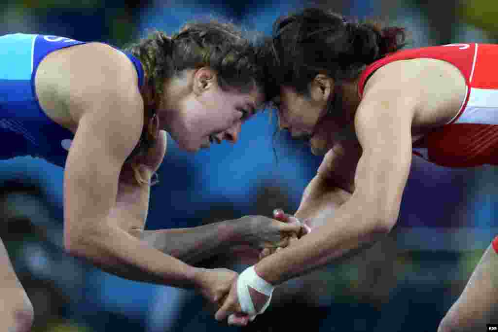 Japan swept the gold medals on the first day of the Olympic women's wrestling tournament. Kaori Icho (right) became the first wrestler in Olympic history to win four gold medals, beating Russia's Valeria Koblova Zholobova 3-2 in the 58-kilogram women's freestyle.
