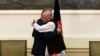 Abdullah Abdullah and Ashraf Ghani embrace after signing a power-sharing agreement at the Presidential Palace in Kabul, September 21, 2014.