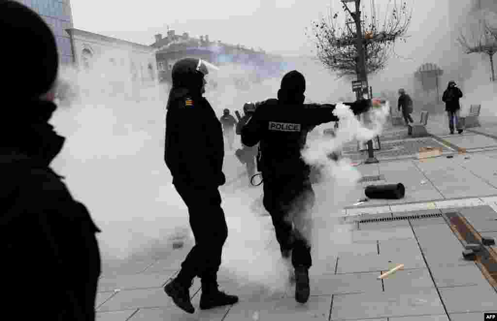 Kosovo riot police throw tear gas during clashes with protesters at a demonstration in Pristina on January 27. (AFP/Armend Nimani)