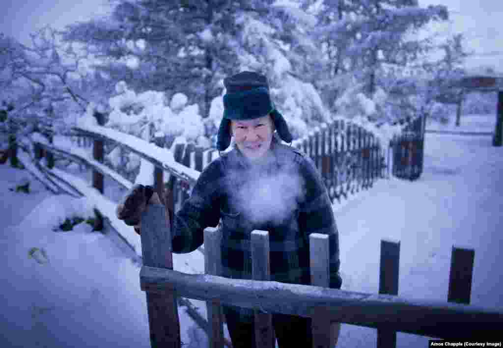 A local in Oymyakon pauses for a quick photo during a toilet run.