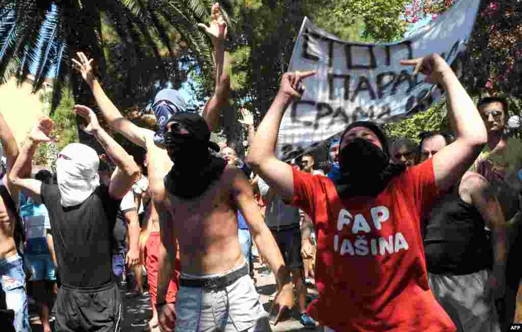 Demonstrators shouting &quot;Kill the gays!&quot; threw stones, bottles, and other objects