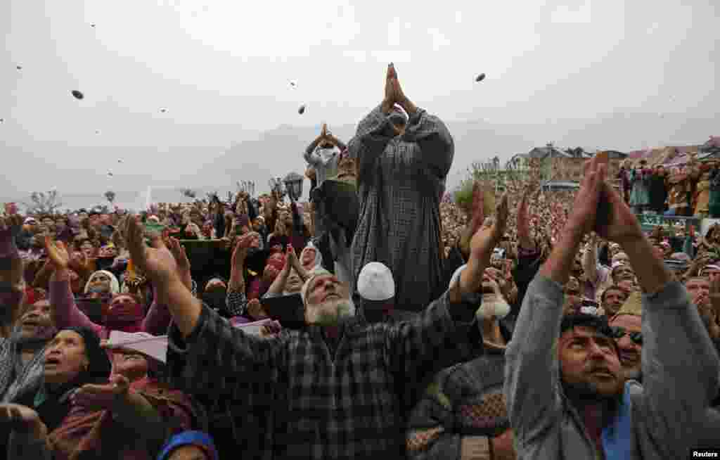 Kashmiri Muslims pray upon seeing a relic believed to be hair from the beard of the Prophet Muhammad during a festival to mark the anniversary of the death of Abu Bakr, one of the companions of the Prophet Mohammad, at the Hazratbal shrine in Srinagar. (Reuters/Danish Ismail)