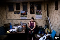 A woman sits inside a makeshift bomb shelter in Donetsk in mid-August.