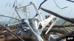 A photo purportedly shows the wreckage of a small lightweight model drone of a type widely available for commercial purchase, lying on branches of wood near Bhimber, a district of Pakistani-administered Kashmir on July 15.
