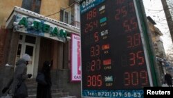 An exchange-rate board in Almaty reflects the fall of the Kazakh tenge on February 11.