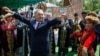 Then-Kazakh President Nursultan Nazarbaev dances with artists during celebrations to mark People's Unity Day in Almaty on May 1, 2016.