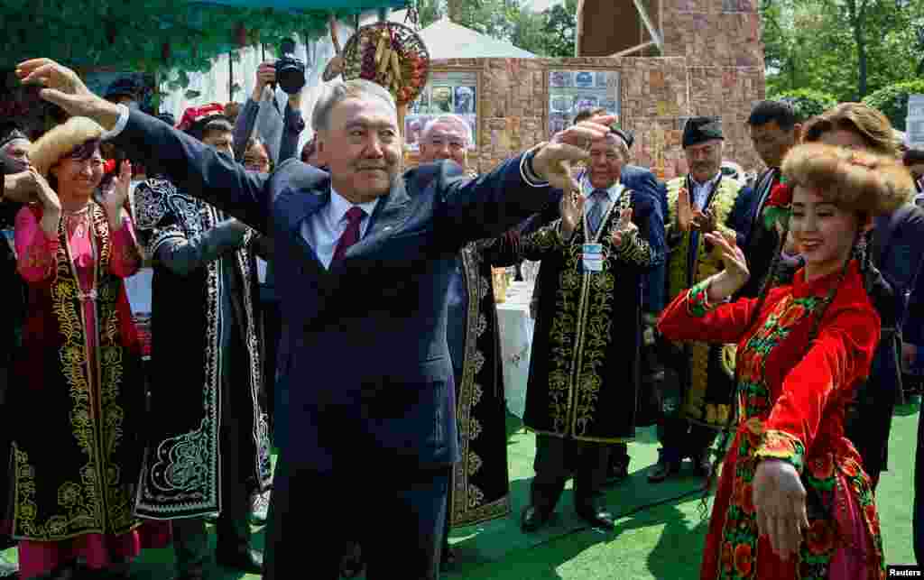 Kazakh President Nursultan Nazarbaev dances with artists during celebrations to mark Kazakhstan People's Unity Day in Almaty on May 1. (Reuters/Shamil Zhumatov)