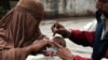A Pakistani health worker administers polio drops to a child during a polio vaccination campaign in Peshawar on March 3.