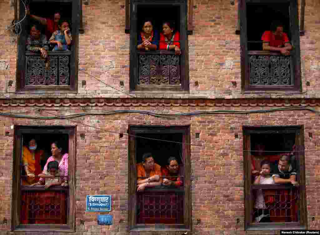 People observe the Nil Barahi mask dance festival, an annual event during which dancers perform while posing as various deities that people worship to seek blessings, in Bode, Nepal. (Reuters/Navesh Chitrakar)