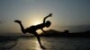 An Afghan youth jumps into a river on the outskirts of Jalalabad. (AFP/Noorullah Shirzada)