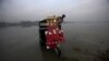 A man washes his rickshaw on the shores of the Sardaryab River in Charsadda near Peshawar, Pakistan, on December 4. (Reuters/​Fayaz Aziz)