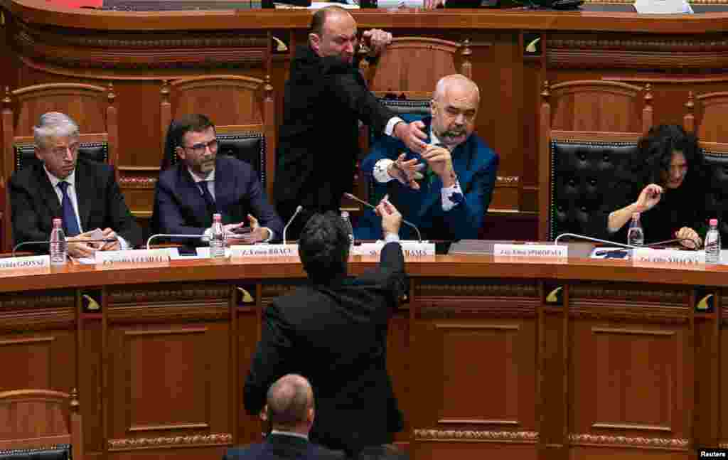 Albanian Prime Minister Edi Rama reacts as ink is thrown at him by members of the opposition during a parliamentary session in Tirana. (Reuters/Stringer)
