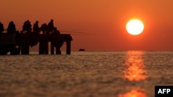 Ukraine - People fishing during sunset in the Crimean town of Alushta, May 4, 2014