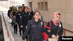 Suspected supporters of U.S.-based cleric Fethullah Gulen are escorted by police as they arrive at a courthouse in Bursa in April.