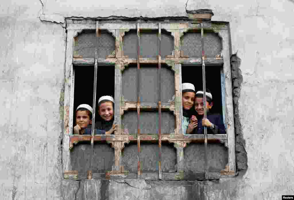 Afghan students look out a window at their religious school in Kabul.(Reuters/Omar Sobhani)