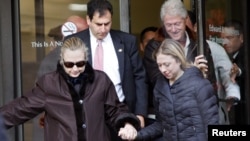 U.S. Secretary of State Hillary Clinton (left) leaves New York Presbyterian Hospital with husband Bill (top right) and daughter Chelsea (right) in New York on January 2.