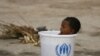 Two-year-old Sanjev Kumar sits in a water bucket provided by the UN refugee agency in a Pakistani Army flood-relief camp in Sukkur, Sindh Province, on August 30. Flood-stricken Pakistan <b><a href="http://www.rferl.org/content/Pakistan_Devastation_Hits_High_Water_Mark/2144706.html">urgently needs more international aid</a></b> to combat potential instability and extremism, influential U.S. Senator John Kerry said, as hunger and disease threaten millions of victims. <br /><br />Photo by Athar Hussain for Reuters