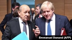 Jean-Yves Le Drian (stânga) și șeful diplomației britanice, Boris Johnson